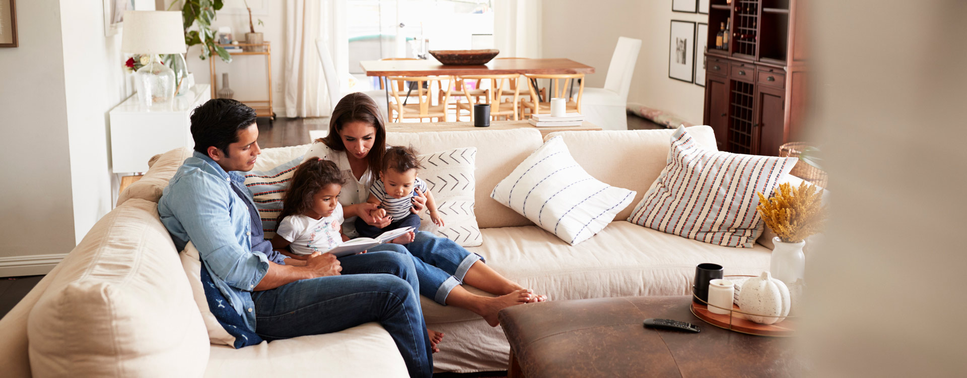 Family reading book in comfortable home